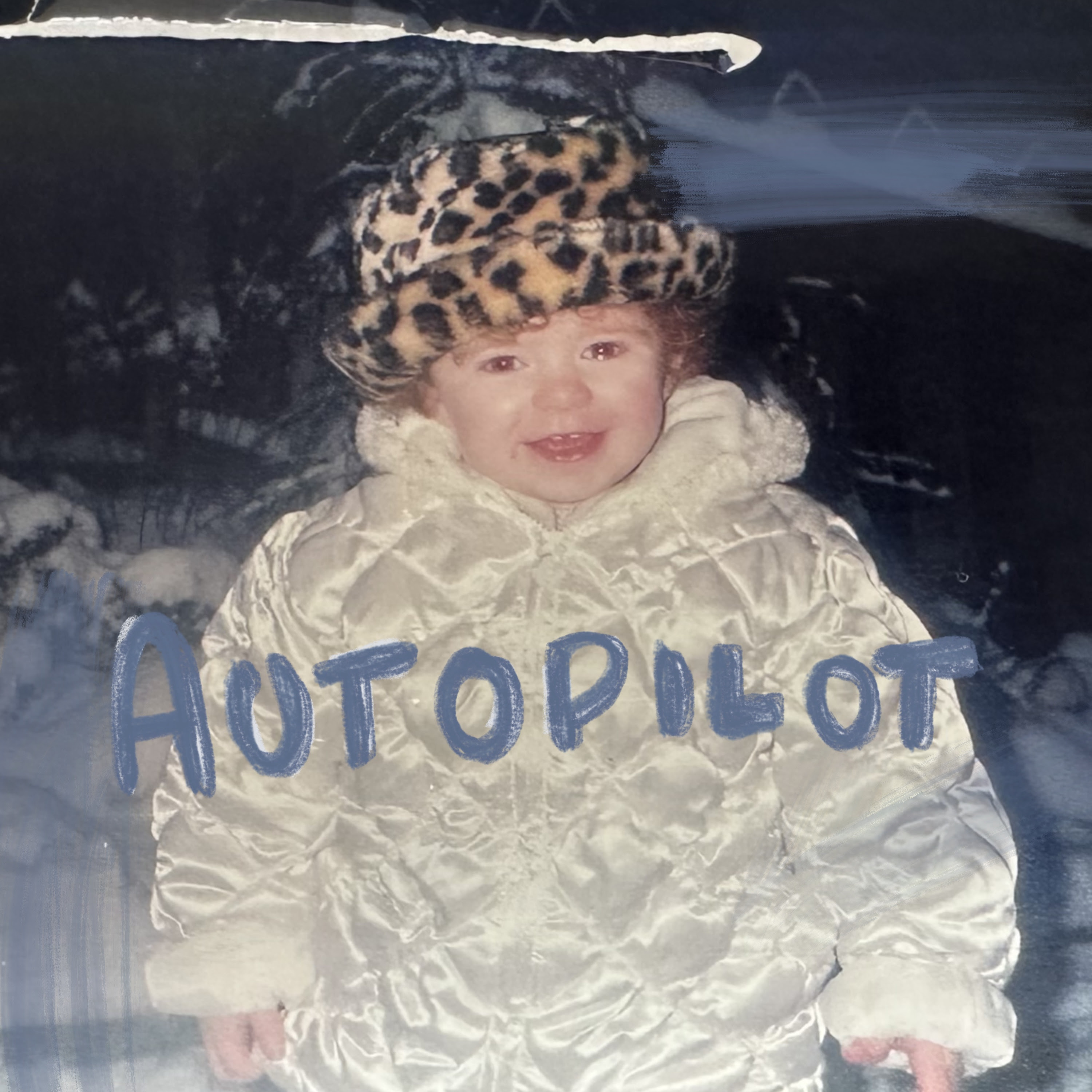 Toddler ROE in a big puffy white coat and leopard print hat with song title 'Autopilot' drawn in blue