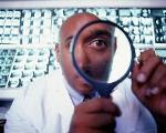 Photograph of a male doctor looking through a magnifying glass