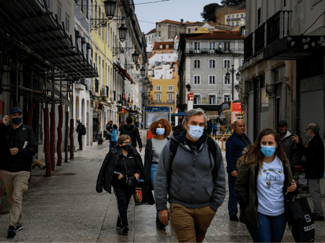 People wear face masks in downtown Lisbon on October 28, 2020. - The Portuguese support the wearing of the compulsory mask outdoors, a measure that came into force today, in order to stem the resumption of the coronavirus epidemic. (Photo by PATRICIA DE MELO MOREIRA / AFP) (Photo by PATRICIA …