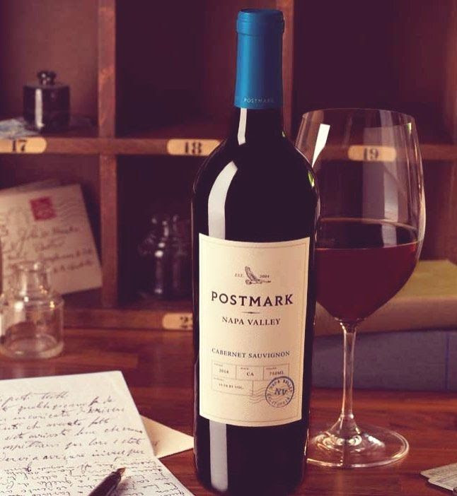 Bottle and glass of  Postmark Cabernet Sauvignon Napa Valley by Duckhorn 2018 on library table