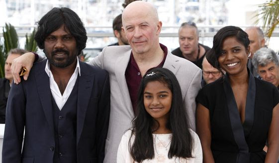 From left, actor Jesuthasan Antonythasan, director Jacques Audiard, actress Claudine Vincent Rottiers and actress Kalieaswari Srinivasan pose for photographers during a photo call for the film Dheepan, at the 68th international film festival, Cannes, southern France, Thursday, May 21, 2015. (AP Photo/Lionel Cironneau)