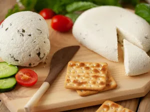 Farmer cheese with crackers, sliced cucumber, and grape tomatoes