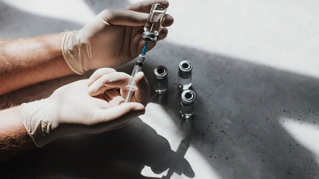 A doctor preparing a shingles vaccine.