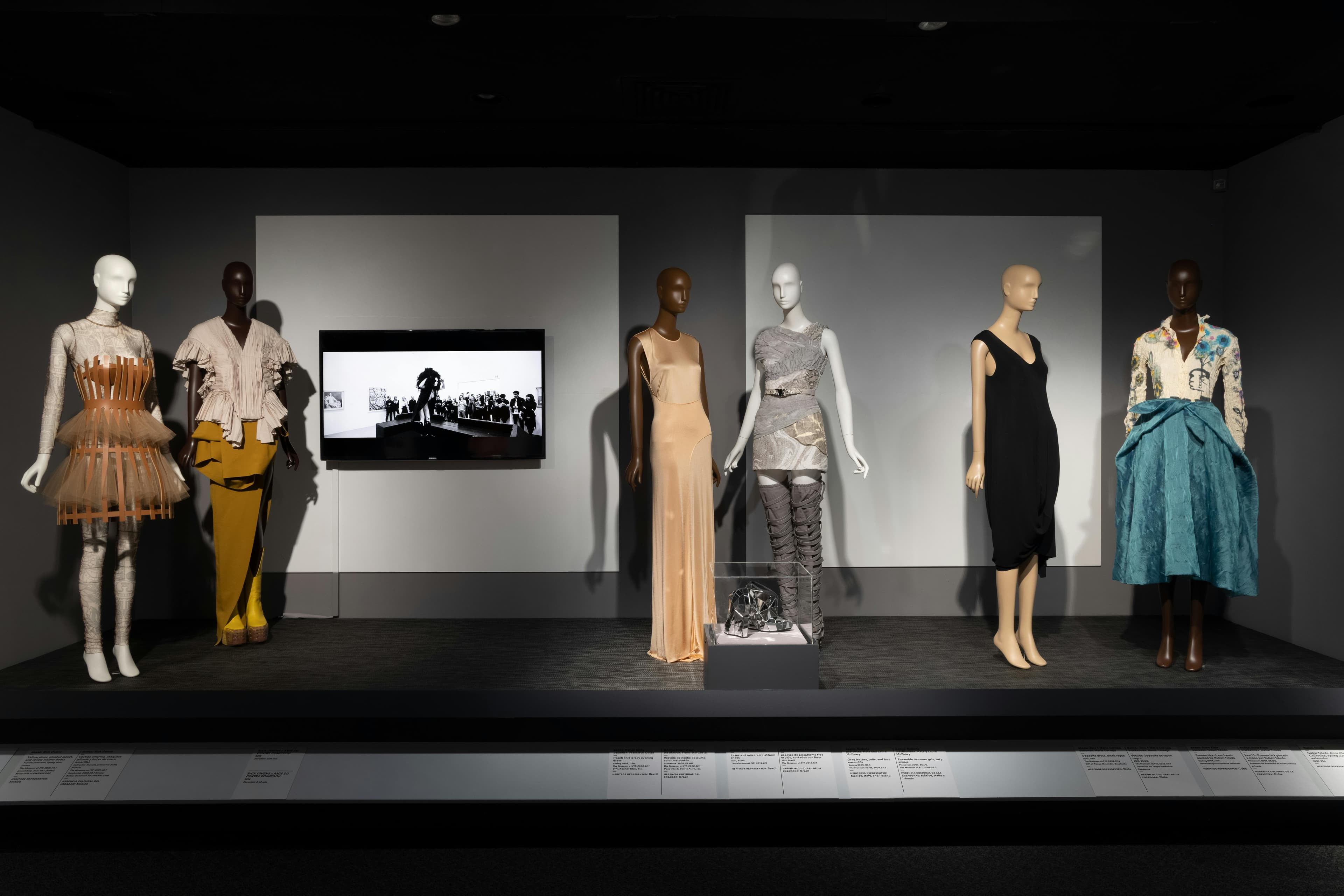 ¡moda hoy! latin american and latinx fashion design today exhibition installation fashion & textile history gallery the museum at fit adult male man person female woman dress monitor necklace mannequin