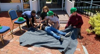 Scouts provide first aid in a CERT Basic Training exercise.