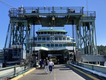 People walking off a ferry on the vehicle transfer span at Friday Harbor terminal