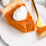 Slice of vegan sweet potato pie on plate with fork