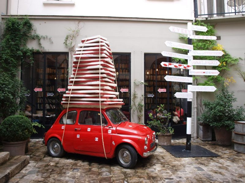 Red car outside of Merci store in Paris by Hello Lovely Studio