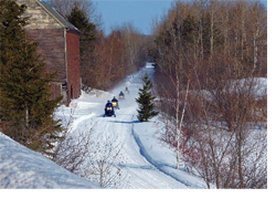 Snowmobiles on a trail in Maine