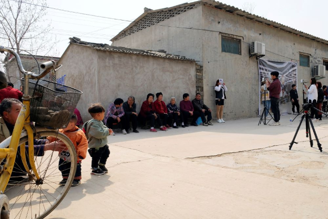 Staff members from Qian Ji Data Co take photos of the villagers for a facial data collection project, which would serve for developing artificial intelligence (AI) and machine learning technology, in Jia county, Henan province, China March 20, 2019