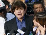 In this March 14, 2012, photo, former Illinois Gov. Rod Blagojevich speaks to the media outside his home in Chicago as his wife, Patti, wipes away tears a day before reporting to prison after his conviction on corruption charges. President Donald Trump is expected to commute the 14-year prison sentence of Blagojevich. The 63-year-old Democrat is expected to walk out of prison later Tuesday, Feb. 18, 2020. (AP Photo/M. Spencer Green) **FILE**