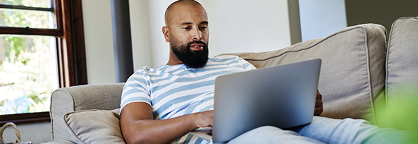 Man checking Service NSW website for opening hours