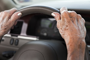 older adult driver older woman's hands on steering wheel