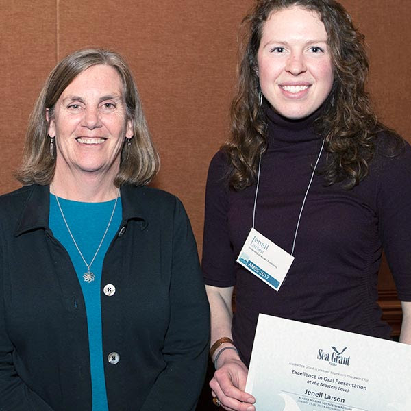 Director with student holding award