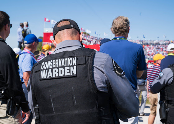 An image of a DNR conservation warden working at an event. 