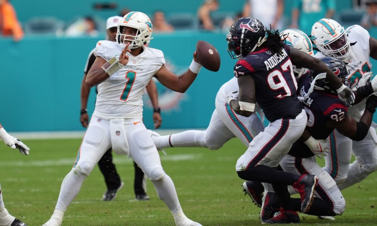 Dolphins QB Tua Tagovailoa (#1) drops back to pass in Sunday's game against the Houston Texans