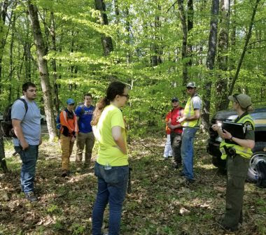 Ranger gives directions to participants during wildland search training