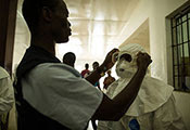 Photo by Morgana Wingard for USAID, Healthcare workers put on personal protective equipment in Liberia
