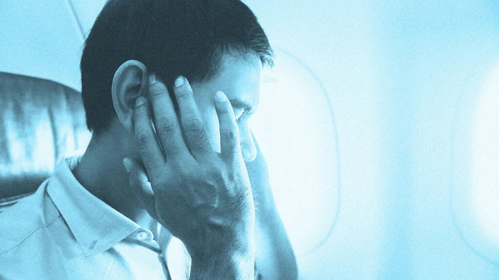 A man thinks, "My ears won't pop but I feel constant pressure," while on a plane.