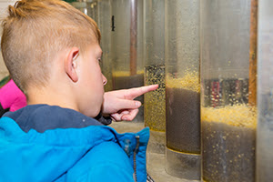 kids look at fish eggs in incubator during tour of Wolf Lake State Fish Hatchery