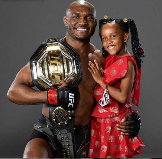  Cute photo of Kamaru Usman and his daughter posing with his belt following his recent win against Jorge Masvidal.