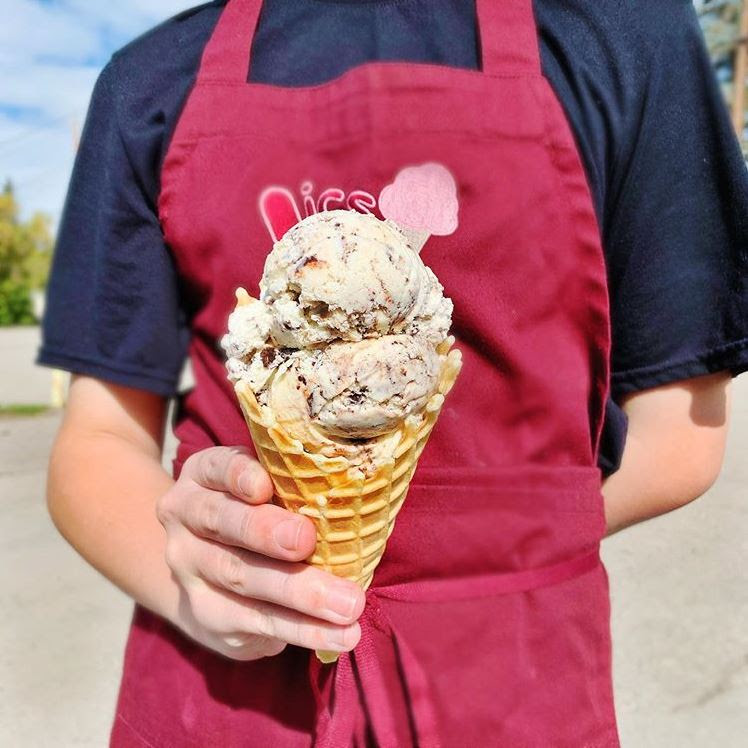 Leavitt's employee holding waffle cone with ice cream