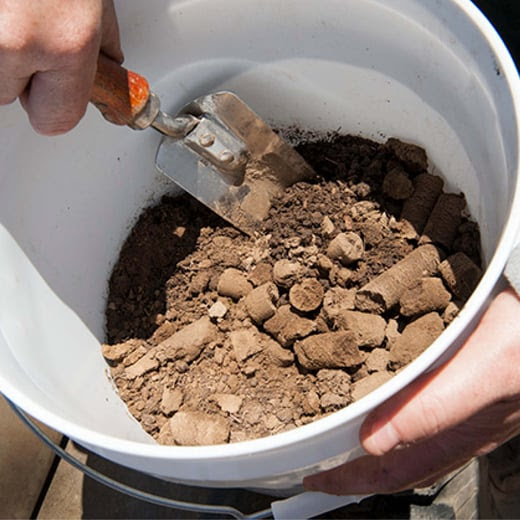 bucket of soil being tested