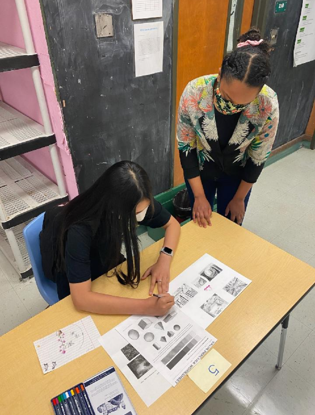 Westlake 8th grader Duc Le working with art teacher, Genya Rocca-Owodunni.