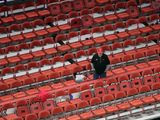 A Platteville High School basketball fan has his pick of seats as the team plays against Arcadia High School during their Division 3 semifinal game at the WIAA girls state basketball tournament Thursday, March 12, 2020, at the Resch Center in Ashwaubenon, Wis. Wisconsin Gov. Tony Evers declared a public health emergency, the state Capitol closed to formal tours and the state high school athletics association moved to drastically limit attendance at remaining winter tournaments Thursday as officials scrambled to prevent the further spread of the new coronavirus in Wisconsin. (Dan Powers/The Post-Crescent via AP) ** FILE **