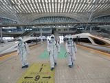 In this photo released by Xinhua News Agency, firefighters conduct disinfection on the platform of Wuhan Railway Station in Wuhan, central China&#39;s Hubei Province, March 24, 2020. Chinese authorities said Tuesday they will end a two-month lockdown of most of coronavirus-hit Hubei province at midnight, though the provincial capital will remain closed til April 8, as domestic cases of the virus continue to subside.(Zhao Jun/Xinhua via AP)