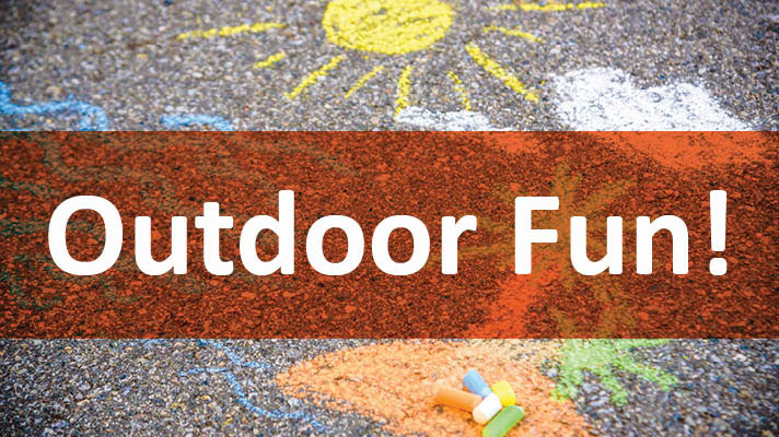 A concrete blacktop with multicolored pieces of chalk and drawings of a sun and clouds. White text on a transparent rust background reads Outdoor Fun! 