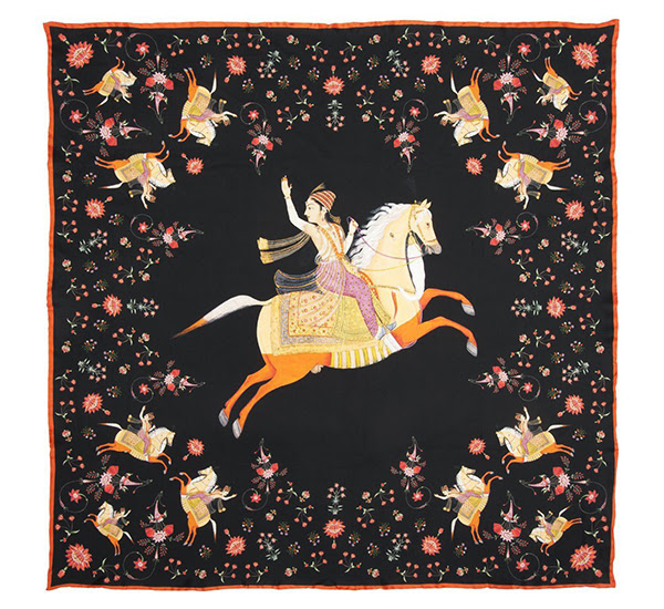 A black and orange square scarf decorated with a horse-rider in the centre.