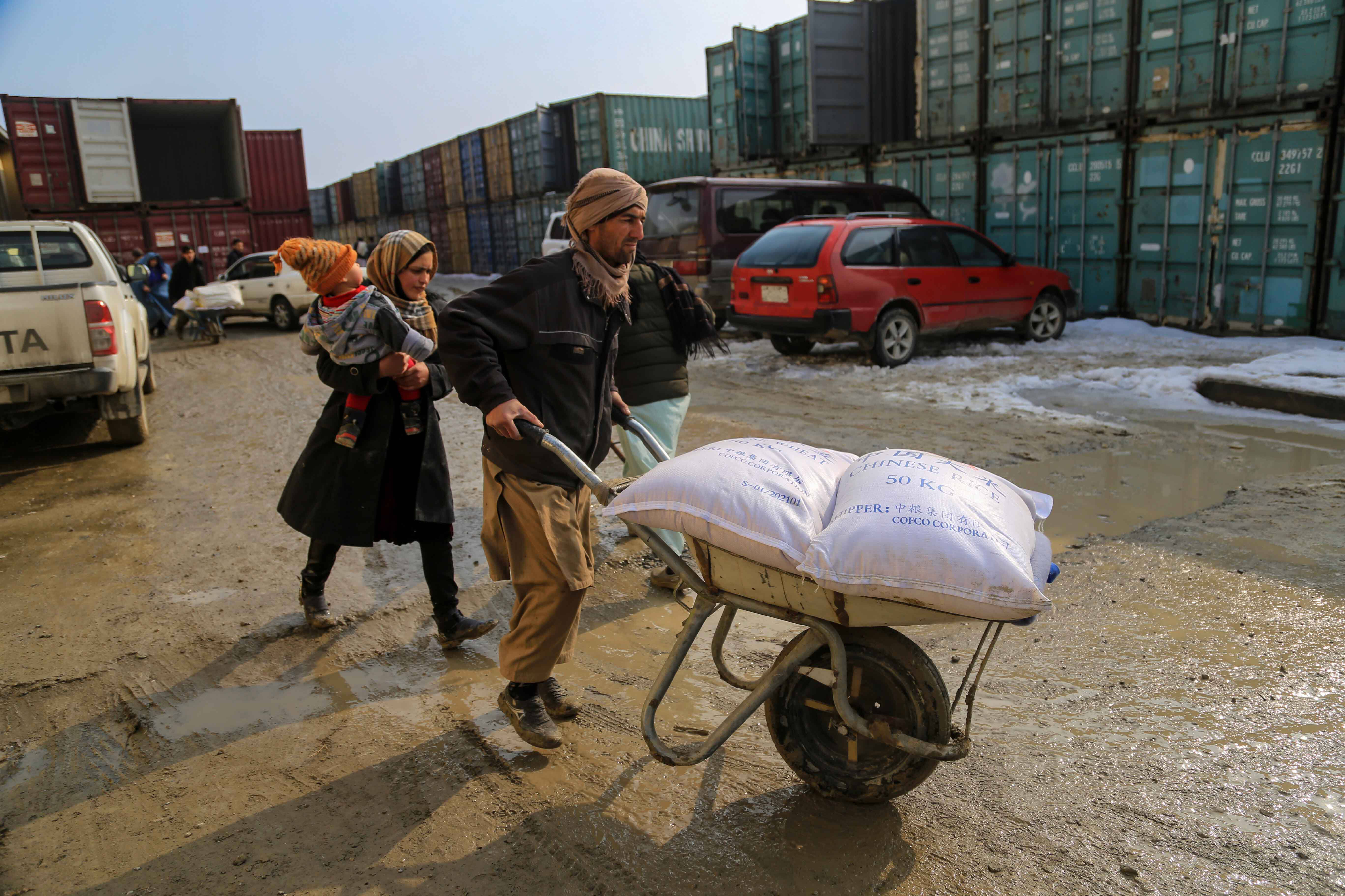 Afghans receive food aid distributed by UNICEF in Kabul on Jan. 18. (Stringer/EPA-EFE/REX/Shutterstock)