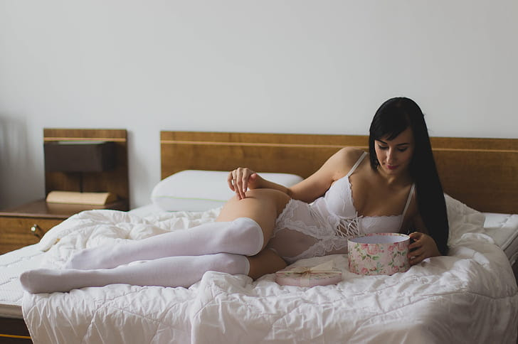 Royalty-Free photo: Woman wearing white bodysuit on bed | PickPik