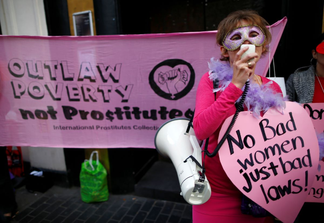 Niki Adams from the English Collective of Prostitutes, speaks through a megaphone during a demonstration at the offices of Soho estates by sex workers against the threat of eviction from a building in Soho, in central London October 9, 2013