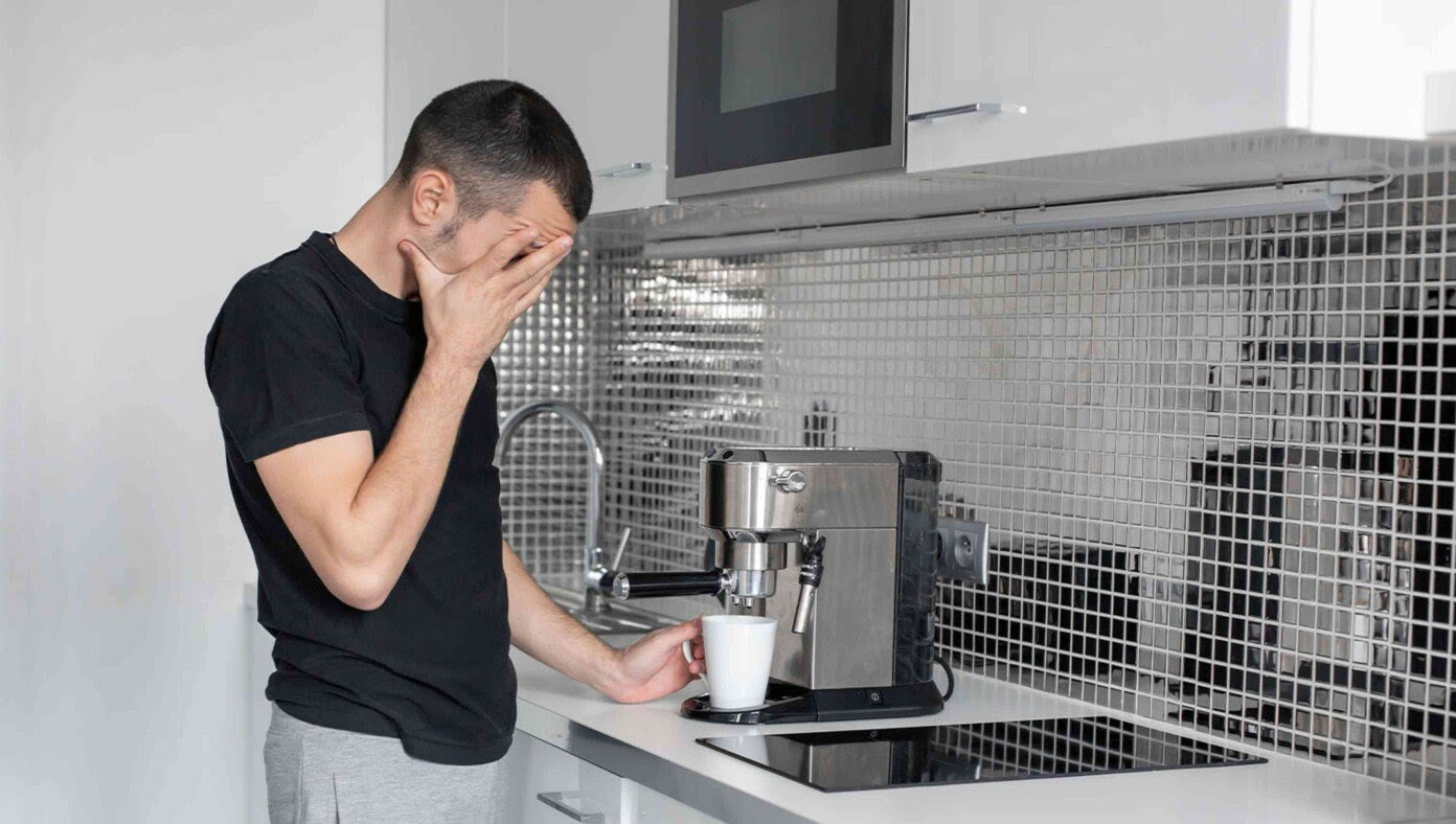 Man Really Struggling To Make Coffee As He Hasn't Had His Morning Coffee Yet