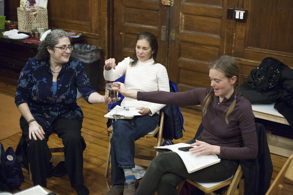 Rebecca Lurie, left, Margaret Rose de Cruz, center, and Helen Zuman share a chocolate treat at a Brooklyn Gift Circle meeting, where attendees offer up—and ask for—services and goods. 