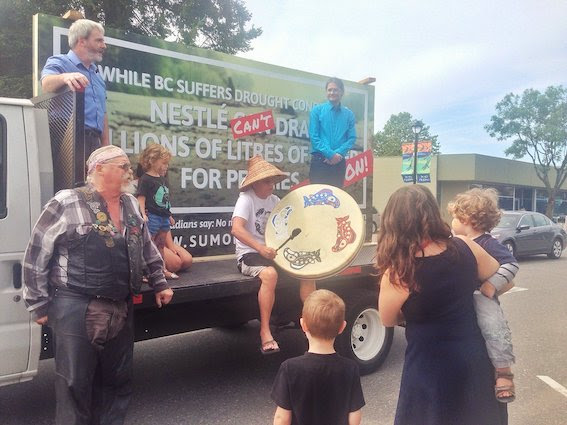 Giant mobile billboard with several generation of people celebrating
