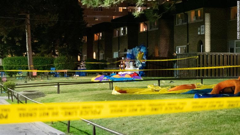 Police tape ropes off the scene of the shooting at an outdoor birthday party
