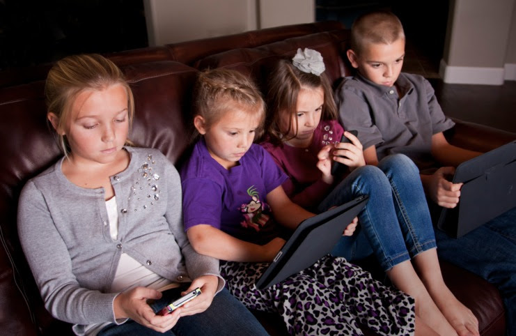 children in front of screens photo