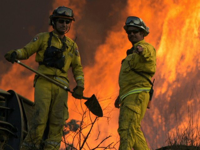 Firefighters monitor the Blue Cut Fire as flames scorch a hills