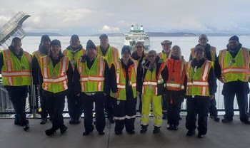 Fourteen people posing for a photo at Mukilteo terminal