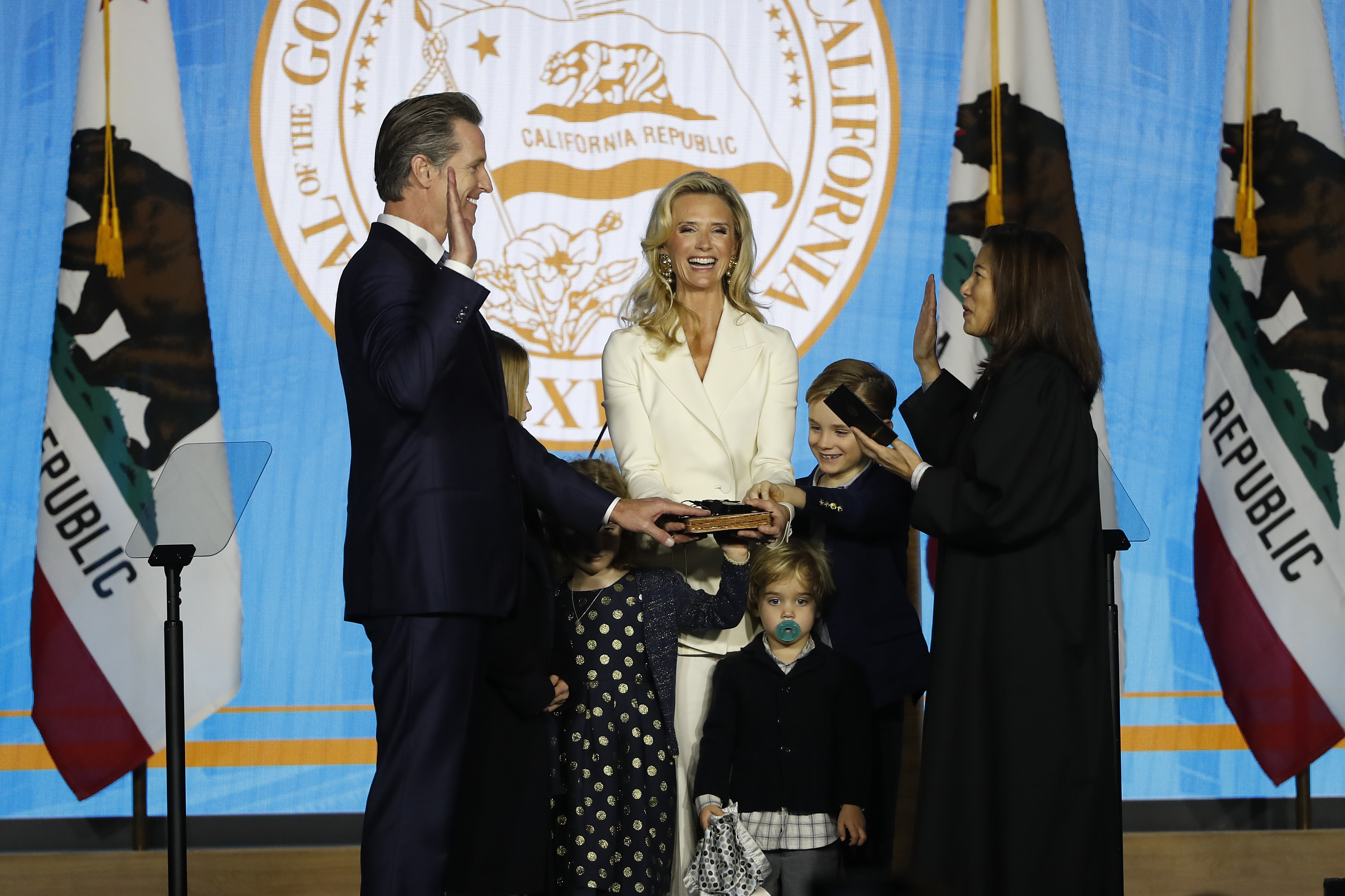 Gavin Newsom (L) is sworn in as governor of California by Calif