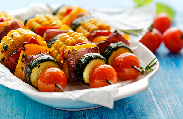 An outdoor buffet dish featuring healthy vegetable kabobs.