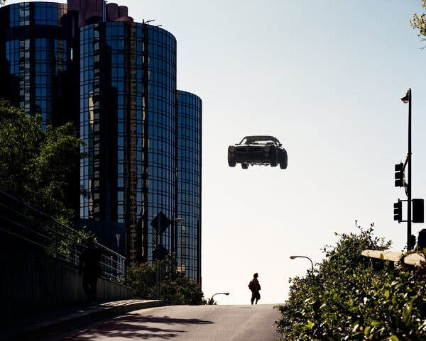 A car hovers well above a city street.
