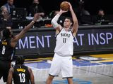 Milwaukee Bucks center Brook Lopez (11) shoots over Brooklyn Nets forward Jeff Green (8) and guard James Harden (13) during the first half of Game 5 of a second-round NBA basketball playoff series Tuesday, June 15, 2021, in New York. (AP Photo/Kathy Willens) **FILE**