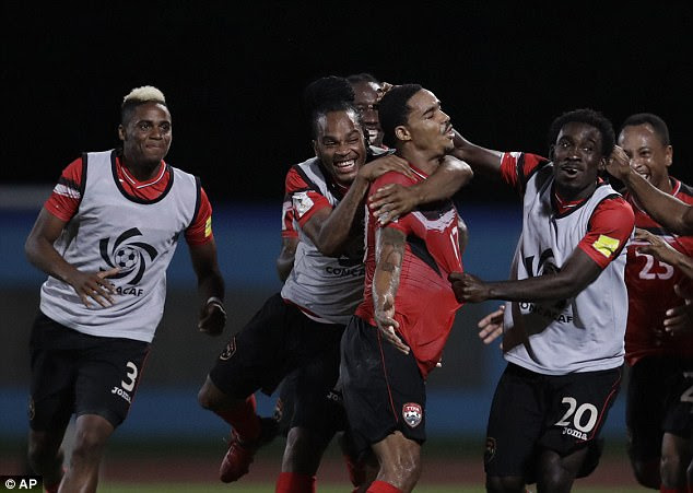 Trinidad and Tobago's Alvin Jones (17) celebrates with his teammates after scoring against U.S. during a World Cup qualifying soccer match in Couva, Trinidad