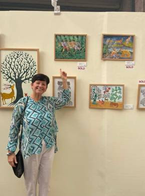 A person pointing at a paintingDescription automatically generated