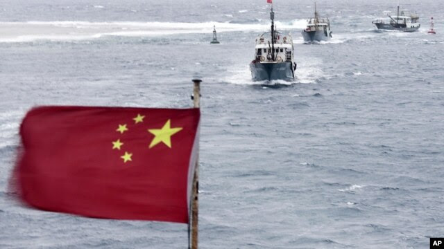 Chinese fishing boats sail in the lagoon of Meiji reef off the island province of Hainan in the South China Sea, July 20, 2012.