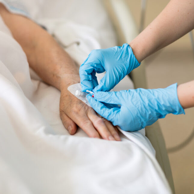 nurse inserting IV